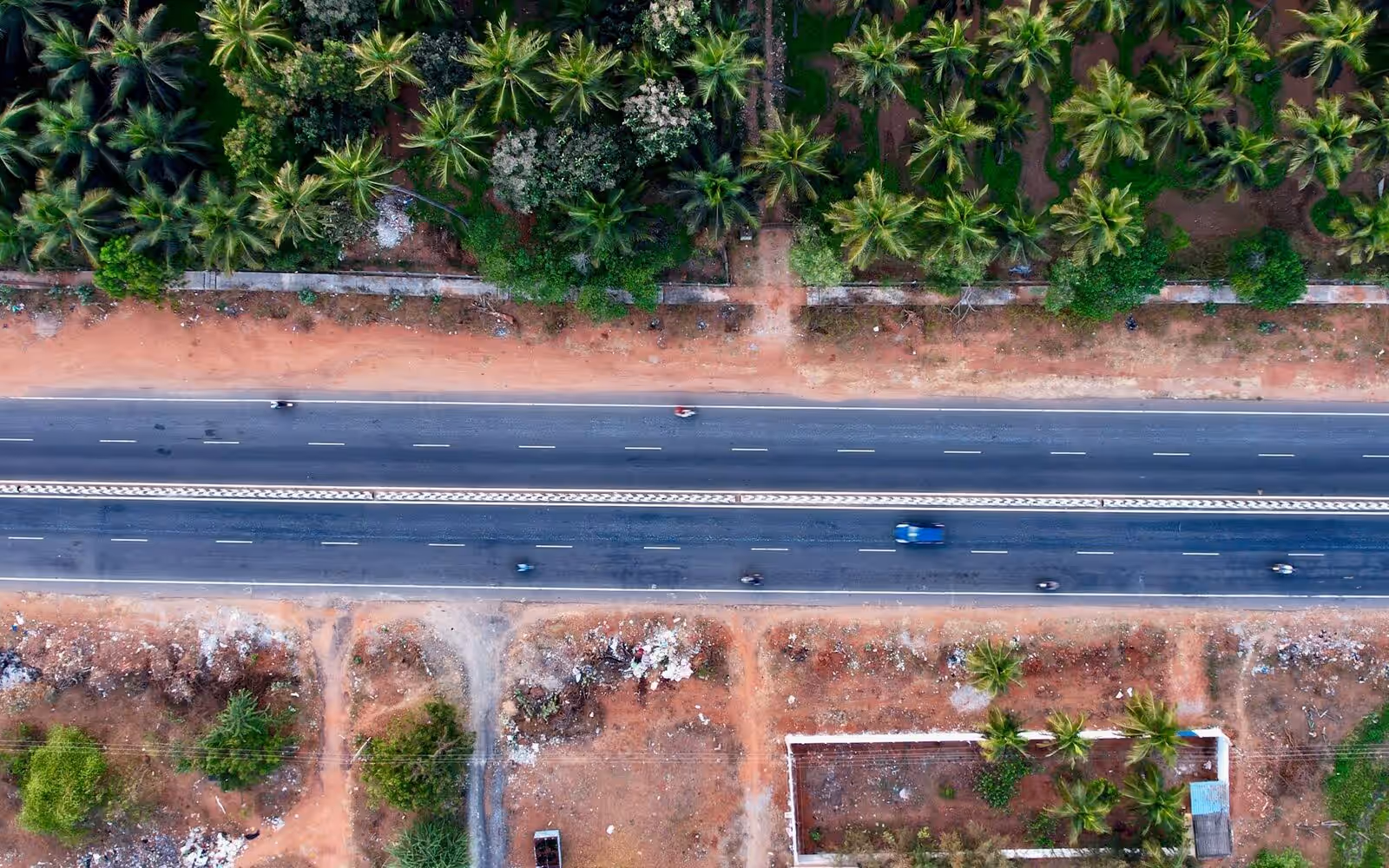 Aerial view of a divided highway cutting through greenery